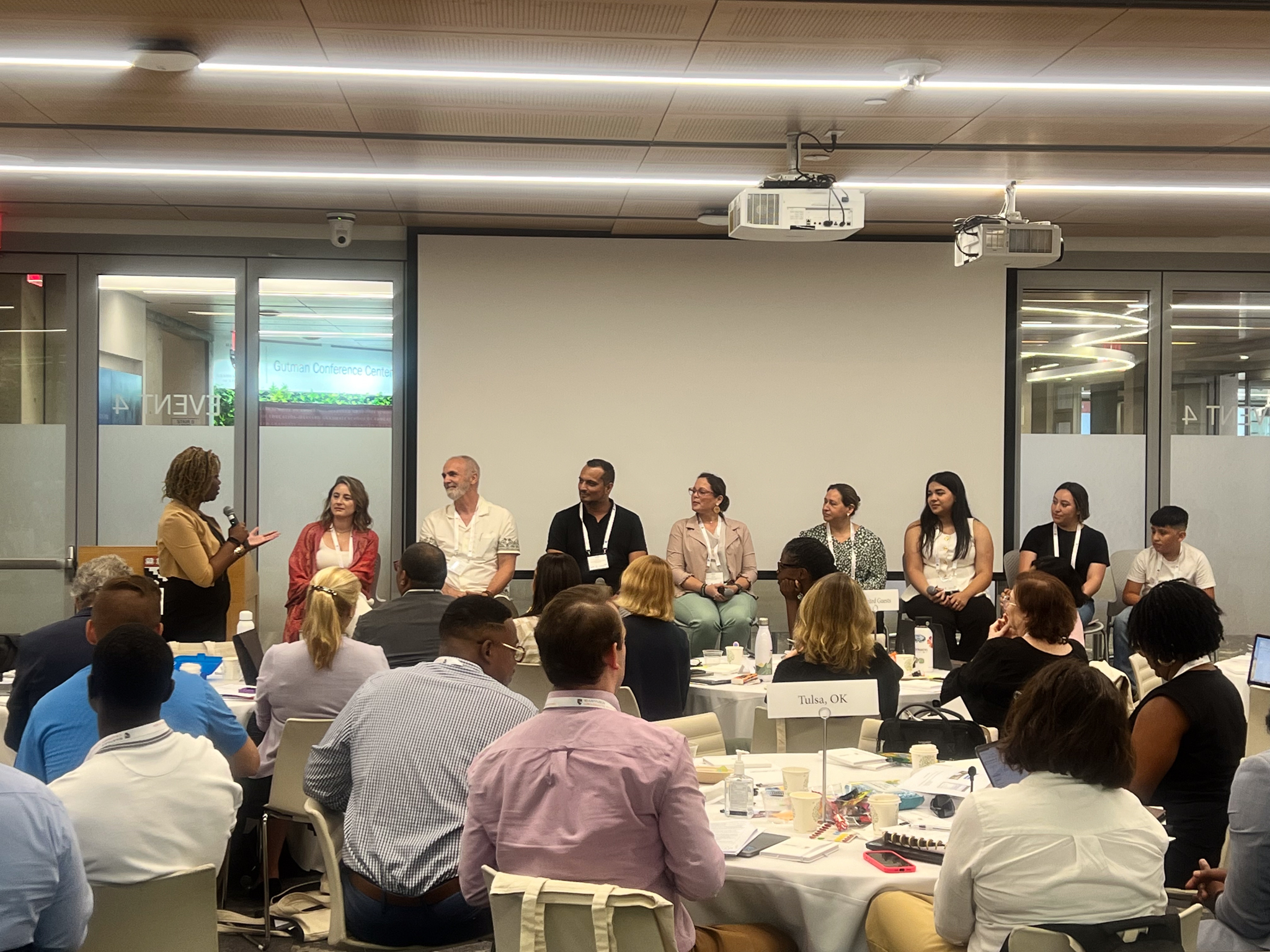 A panel of CPS students educators and families speaking in front of attendees at Harvard's EdResdeign Lab Summer Institute